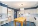 Classic kitchen with white cabinetry, wood center island, and view to another room at 2855 Cedar Canyon Ct, Atlanta, GA 30345