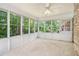 Bright sunroom featuring large windows, a ceiling fan, and neutral carpet, perfect for relaxation and enjoying the outdoor views at 2855 Cedar Canyon Ct, Atlanta, GA 30345