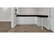 Modern basement bar featuring black granite countertops, white cabinets, and tile flooring at 3305 Millwater Xing, Dacula, GA 30019