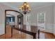 Formal dining room showcasing wood floors, wainscoting, and a decorative chandelier at 3305 Millwater Xing, Dacula, GA 30019