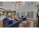 Bright and airy living room with tall windows, wood floors, and elegant blue sofas at 3305 Millwater Xing, Dacula, GA 30019