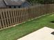 The backyard boasts a beautiful wooden fence and lush green lawn at 607 Tall Timbers, Woodstock, GA 30188