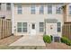 Exterior back view of home featuring a patio and lush landscape at 607 Tall Timbers, Woodstock, GA 30188