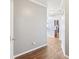 Entryway hallway with wood floors and view into the open concept living areas at 607 Tall Timbers, Woodstock, GA 30188