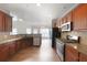Well-equipped kitchen with wood cabinets, stainless appliances and lots of natural light at 607 Tall Timbers, Woodstock, GA 30188