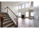 Two-story living room with fireplace and hardwood floors, adjacent to stairs at 607 Tall Timbers, Woodstock, GA 30188