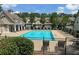 Community pool surrounded by lounge chairs and a black metal fence at 607 Tall Timbers, Woodstock, GA 30188
