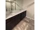Modern bathroom featuring double sinks, dark cabinets, and tile flooring at 1406 Lucan Nw Ln # Wc221, Lawrenceville, GA 30043