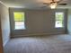 Spacious primary bedroom with carpeted flooring and bright natural light at 1406 Lucan Nw Ln # Wc221, Lawrenceville, GA 30043