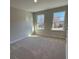 Light-filled bedroom featuring neutral walls and two windows offering outside views at 1406 Lucan Nw Ln # Wc221, Lawrenceville, GA 30043