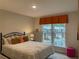 Bedroom with a metal frame bed, large window, and decorative accents at 1406 Lucan Nw Ln # Wc221, Lawrenceville, GA 30043