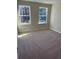 Bright bedroom with natural light streaming through two windows at 1406 Lucan Nw Ln # Wc221, Lawrenceville, GA 30043