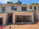 New townhouse construction showing brick facade and two-car garage at 1406 Lucan Nw Ln # Wc221, Lawrenceville, GA 30043