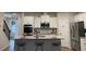 Modern kitchen boasts white cabinets, stainless steel appliances, and a granite island with seating at 1406 Lucan Nw Ln # Wc221, Lawrenceville, GA 30043