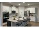 This open kitchen has stainless appliances, granite countertops, and a spacious island at 1406 Lucan Nw Ln # Wc221, Lawrenceville, GA 30043