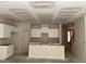 Unfinished kitchen displays white cabinets and a breakfast bar at 1406 Lucan Nw Ln # Wc221, Lawrenceville, GA 30043