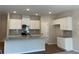 Bright kitchen features white cabinets, granite countertops, and stainless steel appliances at 1406 Lucan Nw Ln # Wc221, Lawrenceville, GA 30043