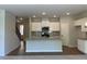 Open concept kitchen with a spacious island, stainless appliances, and modern white cabinetry at 1406 Lucan Nw Ln # Wc221, Lawrenceville, GA 30043