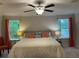 Comfortable main bedroom with plush bedding, bedside lamps, and natural light at 1406 Lucan Nw Ln # Wc221, Lawrenceville, GA 30043