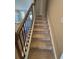 Carpeted staircase with dark wood railing and white risers at 1406 Lucan Nw Ln # Wc221, Lawrenceville, GA 30043