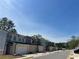 Street view of new townhomes showcases consistent architectural styles and landscaping in the community at 1406 Lucan Nw Ln # Wc221, Lawrenceville, GA 30043