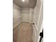 Ample storage space is provided by this walk-in closet with multiple shelves at 1406 Lucan Nw Ln # Wc221, Lawrenceville, GA 30043