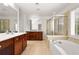 Bright bathroom featuring double vanity, soaking tub, and tiled shower at 2513 Friar Tuck Se Ln # 1, Atlanta, GA 30339