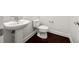 Clean half-bath featuring a pedestal sink, toilet, and hardwood flooring at 2513 Friar Tuck Se Ln # 1, Atlanta, GA 30339