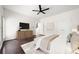 This bedroom is decorated with dark wood floors, a large dresser, and a stylish ceiling fan at 2513 Friar Tuck Se Ln # 1, Atlanta, GA 30339