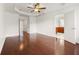 Large bedroom featuring hardwood floors, tray ceiling, and open doors at 2513 Friar Tuck Se Ln # 1, Atlanta, GA 30339