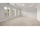 Carpeted bedroom with bright, natural light and tray ceilings at 2513 Friar Tuck Se Ln # 1, Atlanta, GA 30339