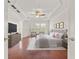 Bright bedroom with hardwood floors, tufted headboard, sitting area, and large windows at 2513 Friar Tuck Se Ln # 1, Atlanta, GA 30339