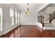 Open dining room with hardwood floors, decorative lighting, and staircase access at 2513 Friar Tuck Se Ln # 1, Atlanta, GA 30339