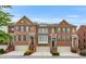 Attractive townhomes boast brick facades, arched windows and attached garages at 2513 Friar Tuck Se Ln # 1, Atlanta, GA 30339