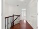 Upstairs hallway showing hardwood floors, closet, staircase, and natural light at 2513 Friar Tuck Se Ln # 1, Atlanta, GA 30339