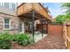 A rear patio looks back at an exterior view of the deck at 2513 Friar Tuck Se Ln # 1, Atlanta, GA 30339