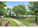 Community pool surrounded by lush greenery and a paved path for easy access at 2513 Friar Tuck Se Ln # 1, Atlanta, GA 30339