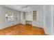 Bedroom featuring a built-in desk with shelves, wood floors, and a window at 2517 Birchwood Ne Dr, Atlanta, GA 30305