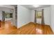 Bright bedroom with hardwood floors, neutral walls, window with curtains, and connects to an adjacent room at 2517 Birchwood Ne Dr, Atlanta, GA 30305
