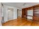 This bedroom has hardwood floors, a ceiling fan, and built-in shelving at 2517 Birchwood Ne Dr, Atlanta, GA 30305