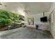 Inviting covered patio with a ceiling fan, stone fountain, and serene backyard views, perfect for relaxation at 2517 Birchwood Ne Dr, Atlanta, GA 30305