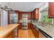 Kitchen featuring stainless steel appliances, granite countertops, wooden cabinetry, and large stainless steel sink at 2517 Birchwood Ne Dr, Atlanta, GA 30305
