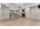 Living room featuring tile floors, fireplace, chandelier, and views of the backyard through large windows at 2517 Birchwood Ne Dr, Atlanta, GA 30305