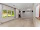 Large living room with fireplace, tile flooring, paneled walls, access to backyard, and windows overlooking the yard at 2517 Birchwood Ne Dr, Atlanta, GA 30305