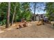 Community playground surrounded by mature trees featuring slides and various play equipment at 2517 Birchwood Ne Dr, Atlanta, GA 30305