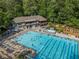 Aerial view of a large pool area with a clubhouse, lounge chairs, and a hot tub for community members at 2517 Birchwood Ne Dr, Atlanta, GA 30305