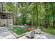 Spacious backyard with a playground and a dart board surrounded by lush greenery at 2535 Hampton Trl, Cumming, GA 30041