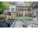 Expansive backyard showcasing an artificial turf lawn, a patio with comfortable seating, and a lush garden area for relaxation at 2535 Hampton Trl, Cumming, GA 30041