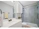 This bathroom has a glass enclosed shower with a white vanity and gray walls at 2535 Hampton Trl, Cumming, GA 30041
