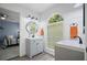 This bathroom features a modern sink, cabinets, wood-look floors, and a large window at 2535 Hampton Trl, Cumming, GA 30041